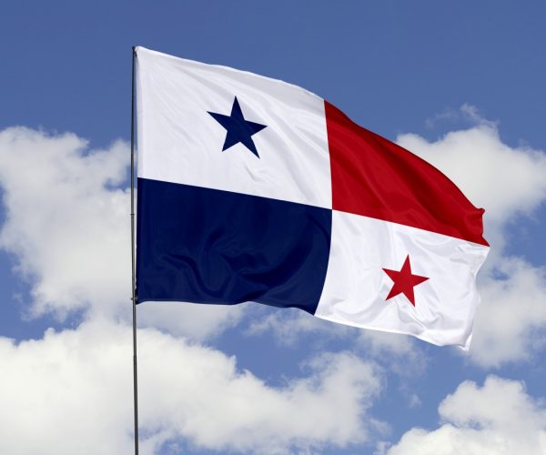 Panama Flag is Waving Against in the Sky. 3d illustration flag of Panama. Panama flag isolated on the blue sky.